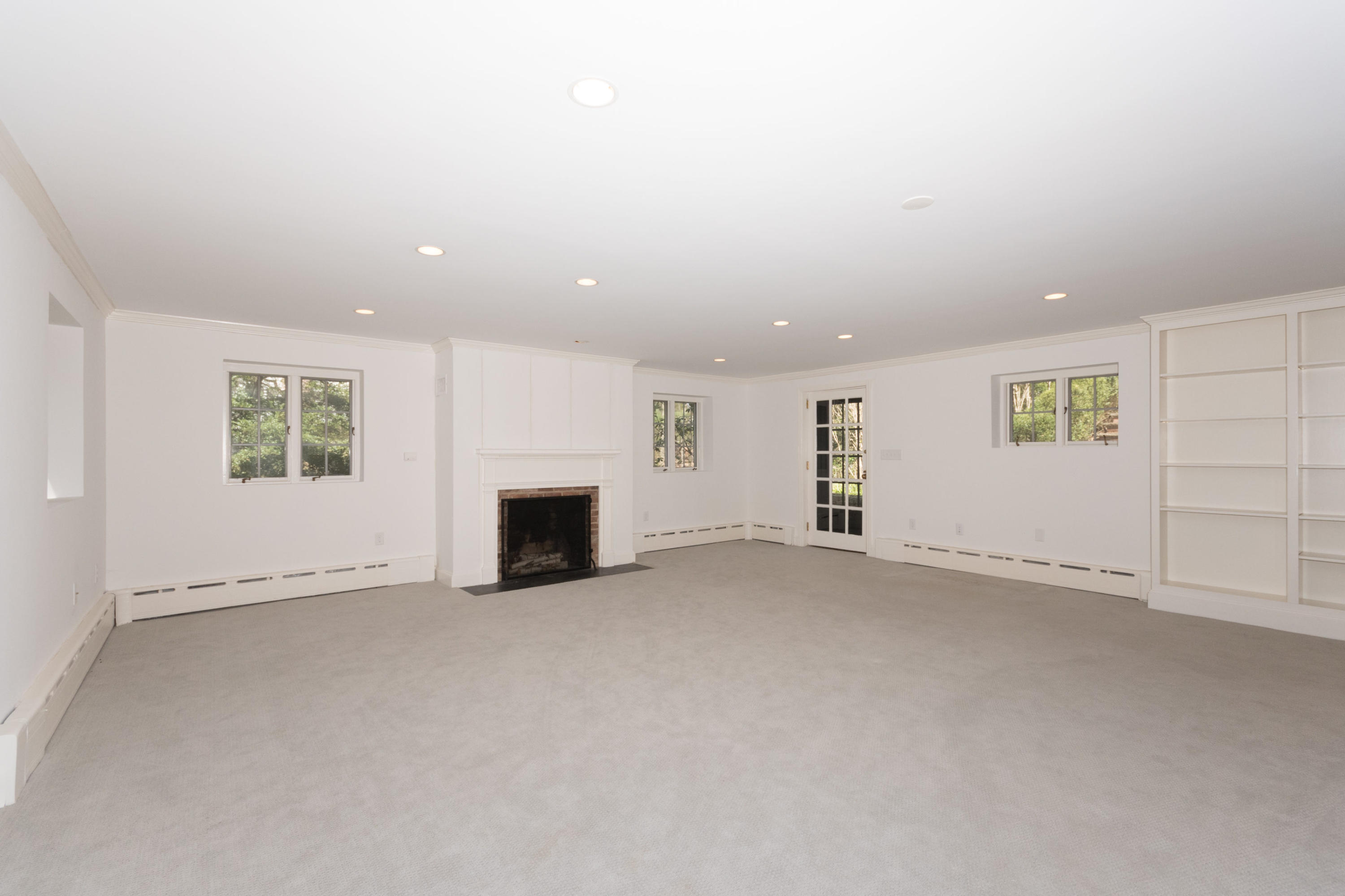 170 Ridge Acres Road Darien, CT 06820 - Photo 34 of 50 an empty room with fireplace and windows