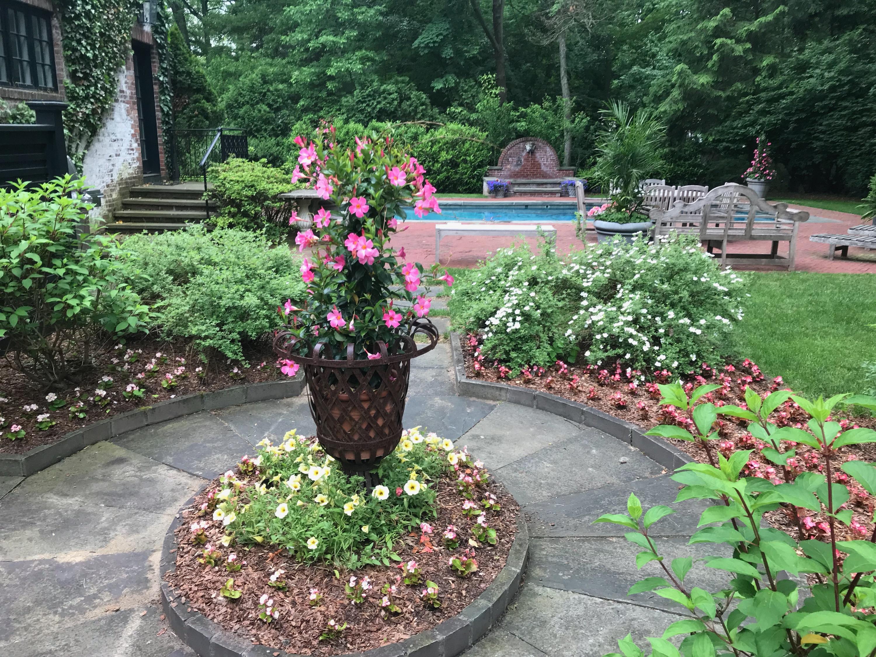 170 Ridge Acres Road Darien, CT 06820 - Photo 37 of 50 a wooden bench sitting in middle of flowers