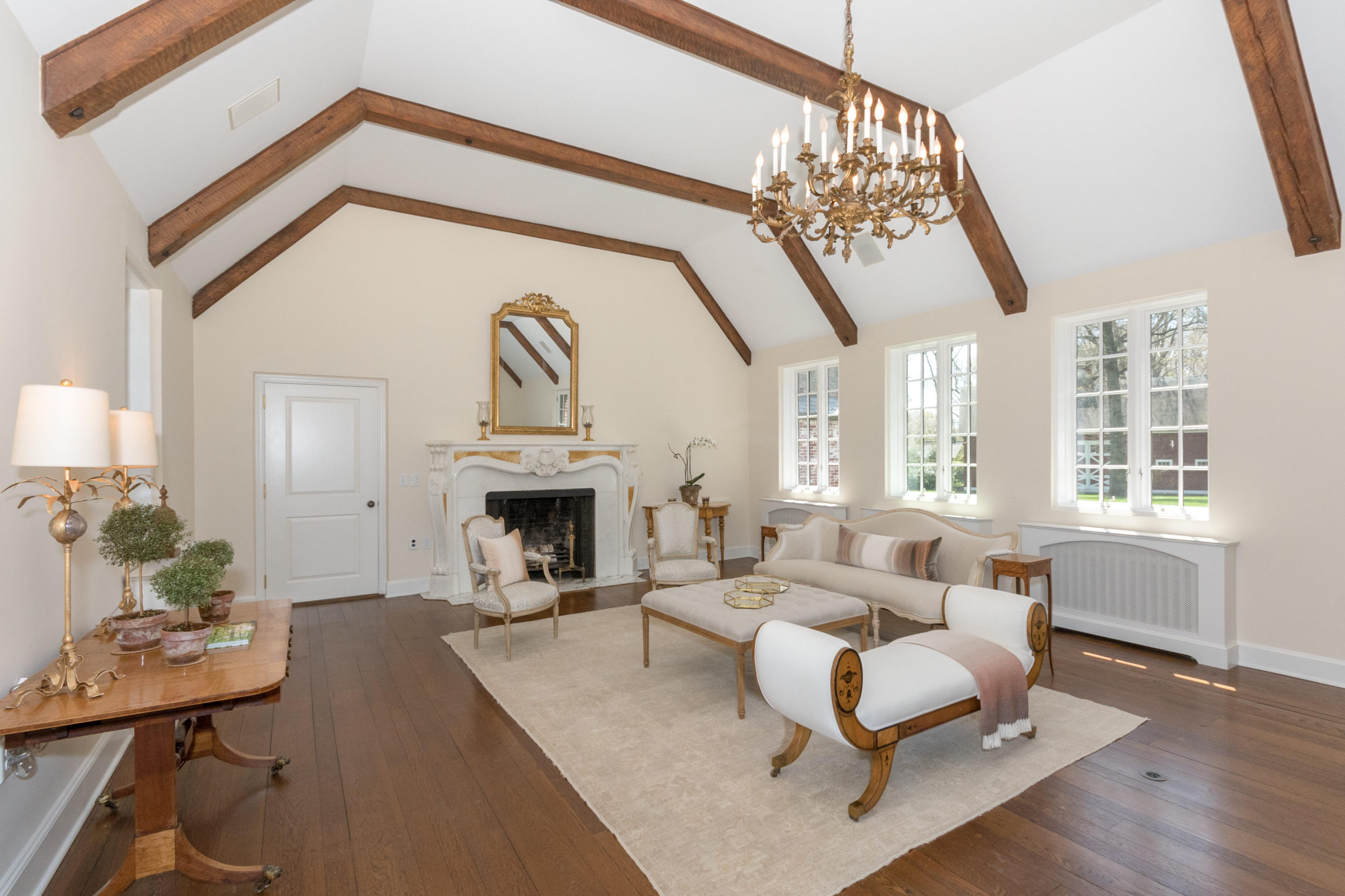 170 Ridge Acres Road Darien, CT 06820 - Photo 8 of 50 a living room with furniture a fireplace and a chandelier