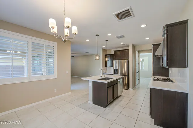 a kitchen with stainless steel appliances granite countertop a sink and a stove