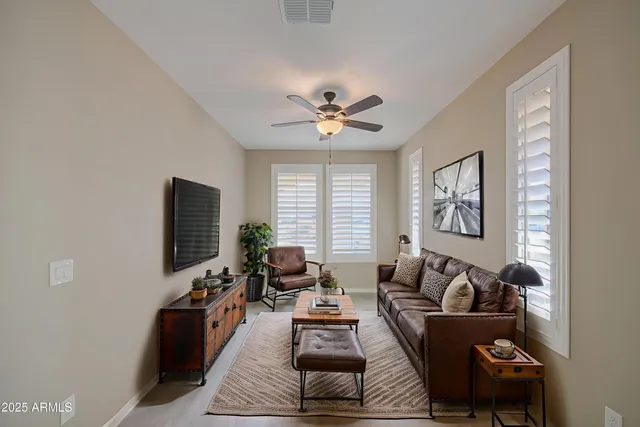 a view of a dining room with furniture a chandelier and wooden floor