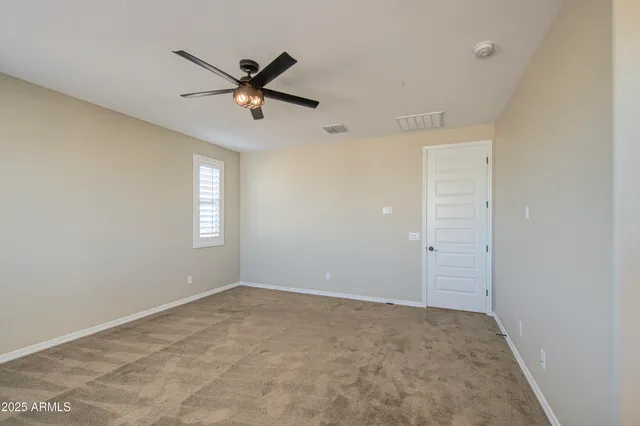 a view of room with a ceiling fan and window