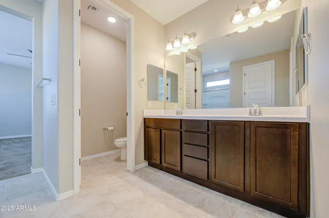 a room with granite countertop a sink and a refrigerator