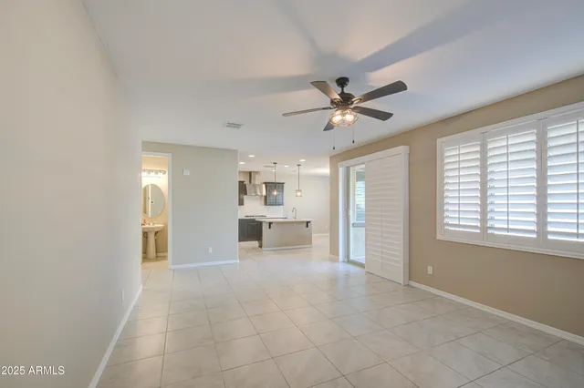 a view of a livingroom with a ceiling fan and window