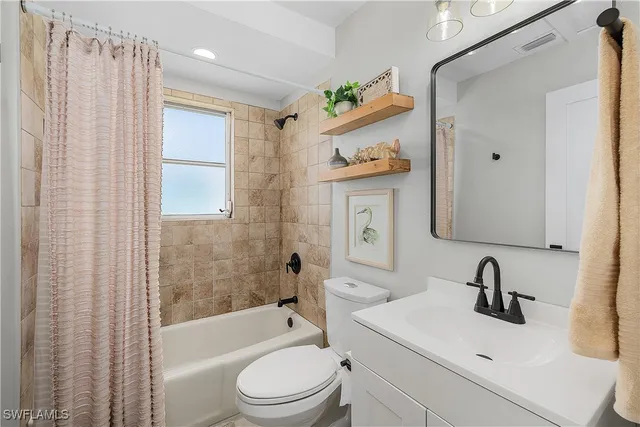 a bathroom with a granite countertop sink mirror and vanity