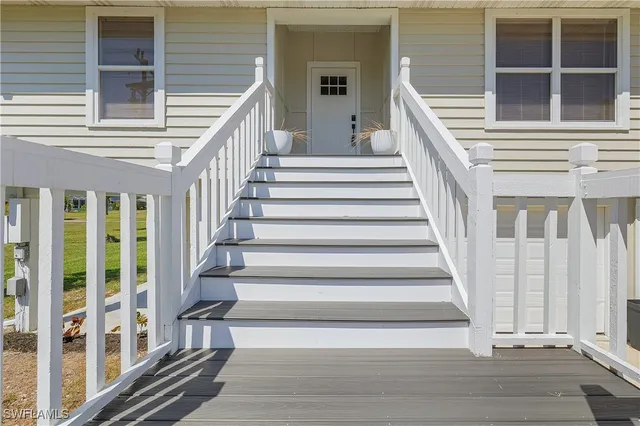 a view of staircase with white walls and windows