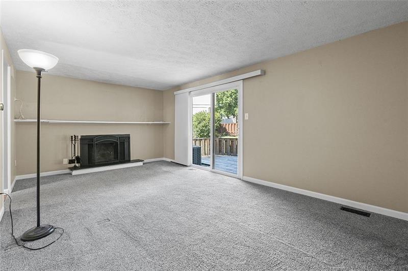 624 Deer Watch Road Bridgeville, PA 15017 - Photo 2 of 7 a view of empty room with fireplace and fan