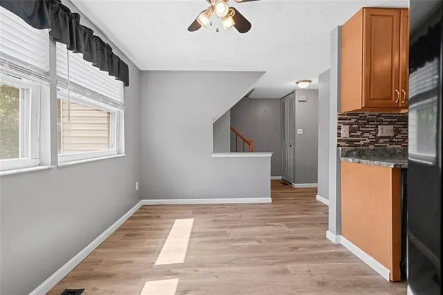 a view of a hallway with wooden floor and staircase