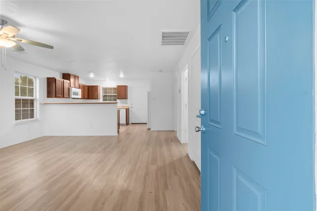 a front view of a house with a garden and trees