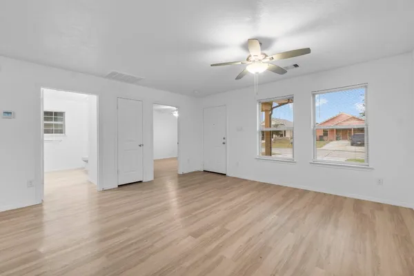a view of a kitchen with wooden floor and windows