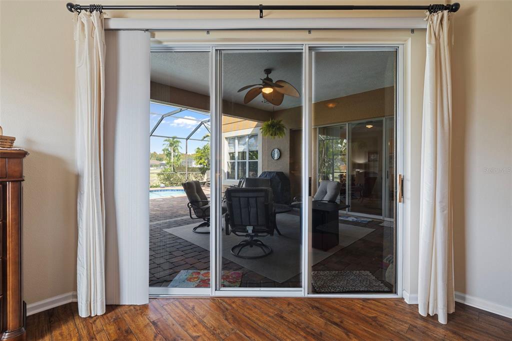25745 Unbridled Court Wesley Chapel, FL 33544 - Photo 12 of 64 a view of a hallway with wooden floor and dining room view