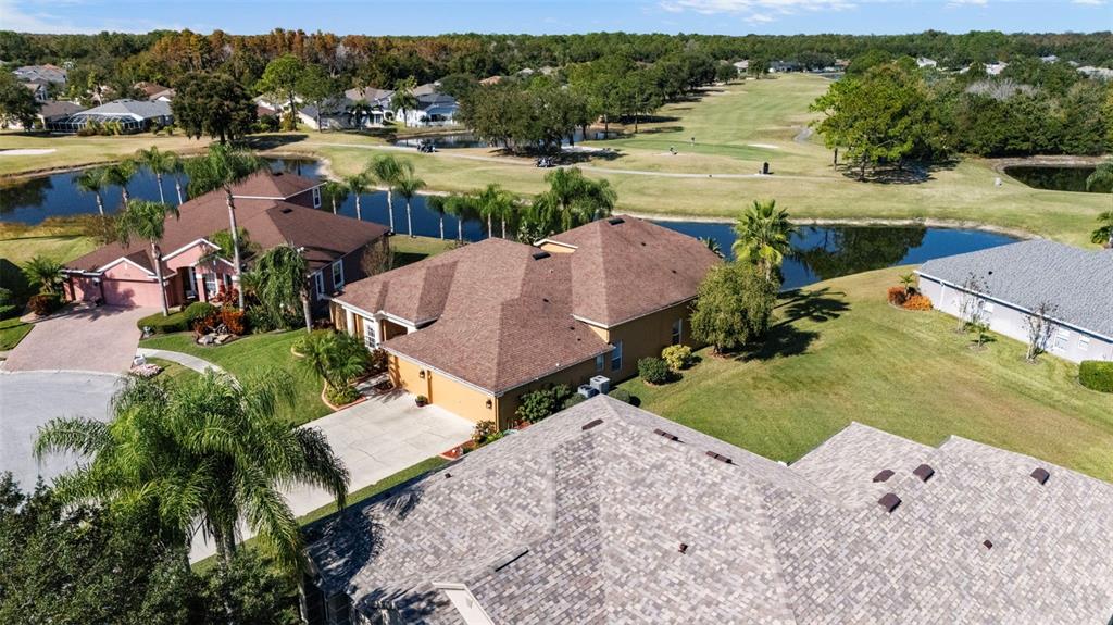 25745 Unbridled Court Wesley Chapel, FL 33544 - Photo 4 of 64 an aerial view of a house with a lake view