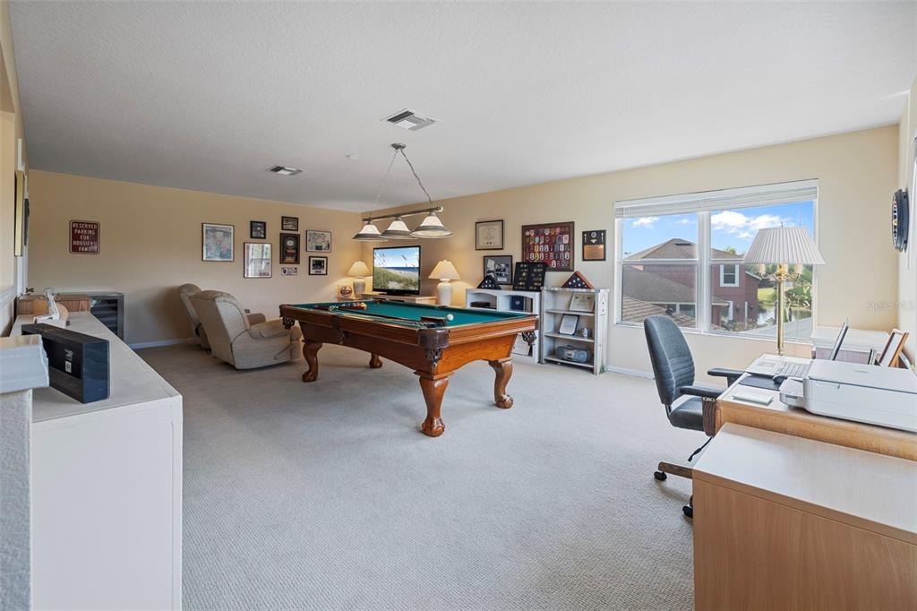 25745 Unbridled Court Wesley Chapel, FL 33544 - Photo 42 of 64 a view of a livingroom with workspace and a window