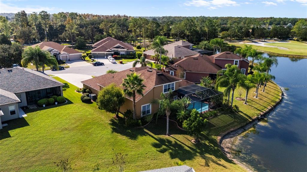25745 Unbridled Court Wesley Chapel, FL 33544 - Photo 53 of 64 an aerial view of residential houses with outdoor space and swimming pool