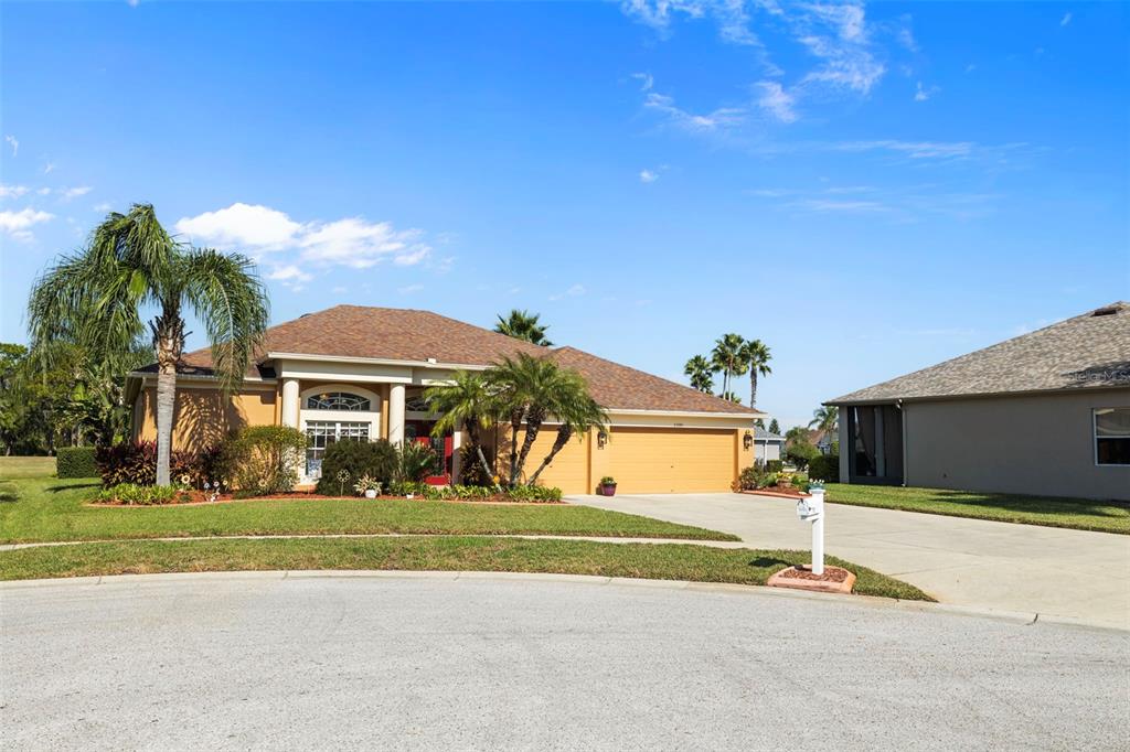 25745 Unbridled Court Wesley Chapel, FL 33544 - Photo 62 of 64 a front view of a house with a yard