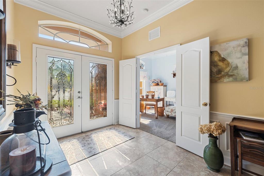 25745 Unbridled Court Wesley Chapel, FL 33544 - Photo 7 of 64 a living room with furniture and a chandelier