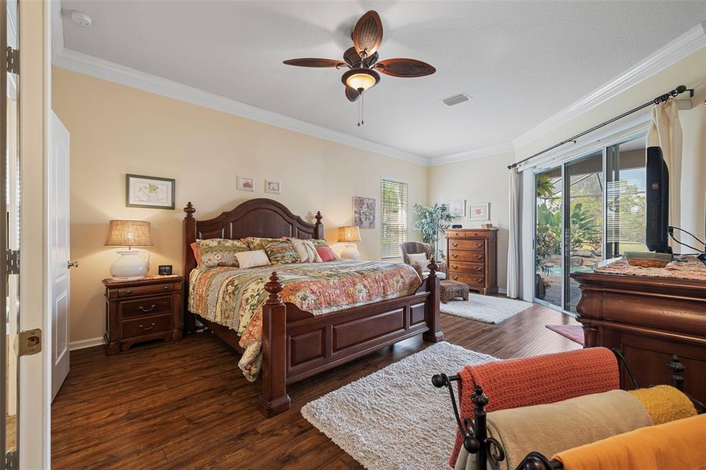 25745 Unbridled Court Wesley Chapel, FL 33544 - Photo 10 of 64 a bedroom with a bed and wooden floor