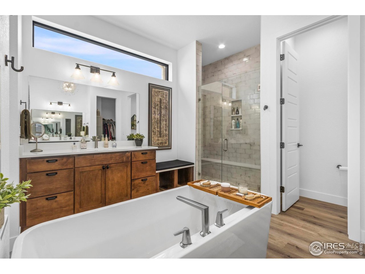 1907 Spring Bloom Drive Windsor, CO 80550 - Photo 11 of 49 Primary Ensuite Retreat; Large custom-tiled shower with bench, free-standing soaking tub