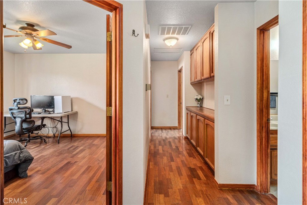 43230 Lookabout Road Lake Hughes, CA 93532 - Photo 13 of 40 a view of a hallway and wooden floor an entryway and livingroom