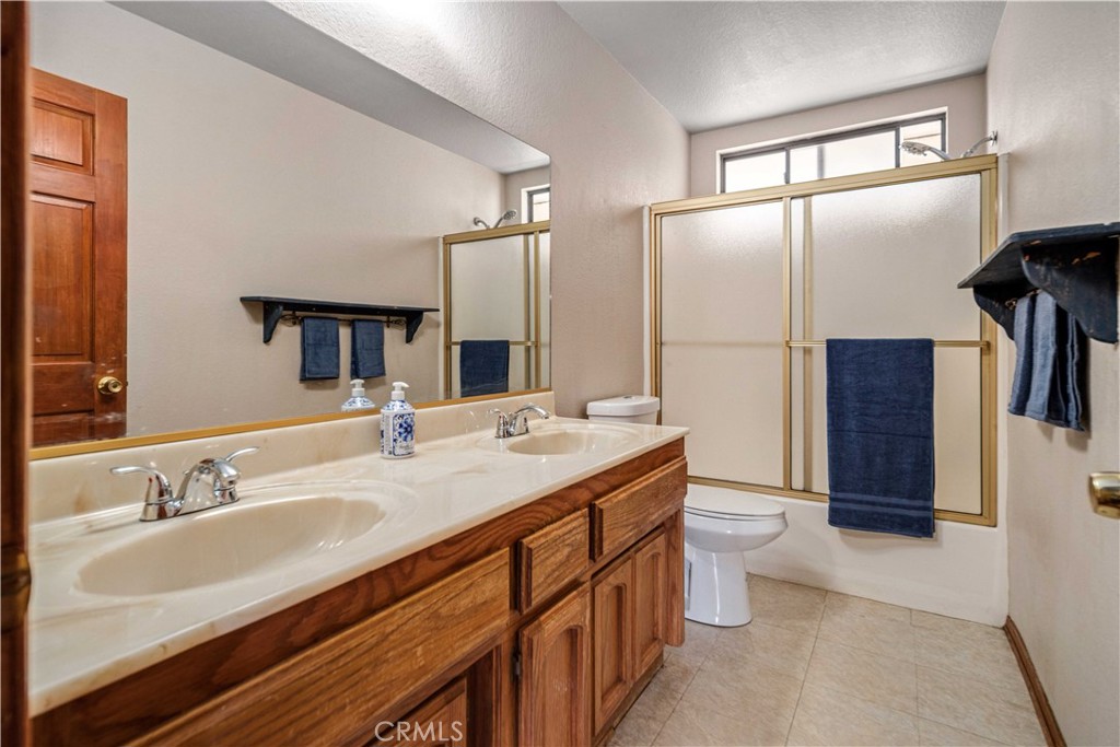 43230 Lookabout Road Lake Hughes, CA 93532 - Photo 15 of 40 a bathroom with a double vanity sink toilet and mirror