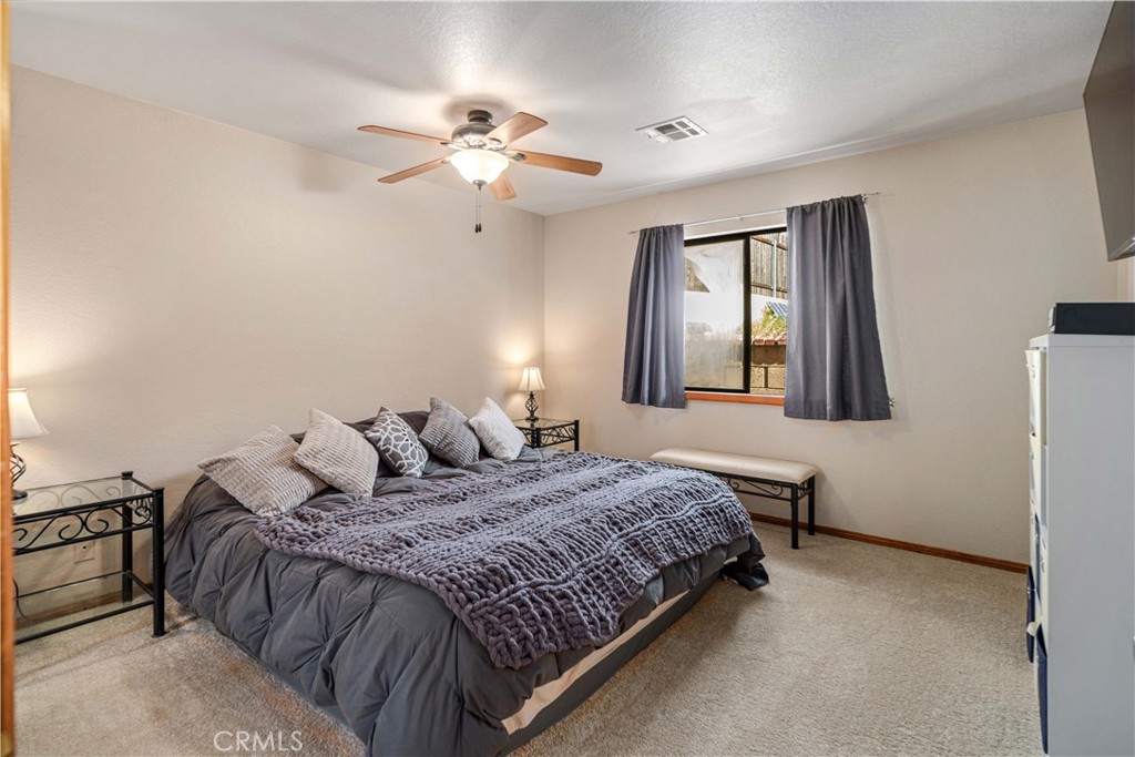 43230 Lookabout Road Lake Hughes, CA 93532 - Photo 16 of 40 a bedroom with a bed and window