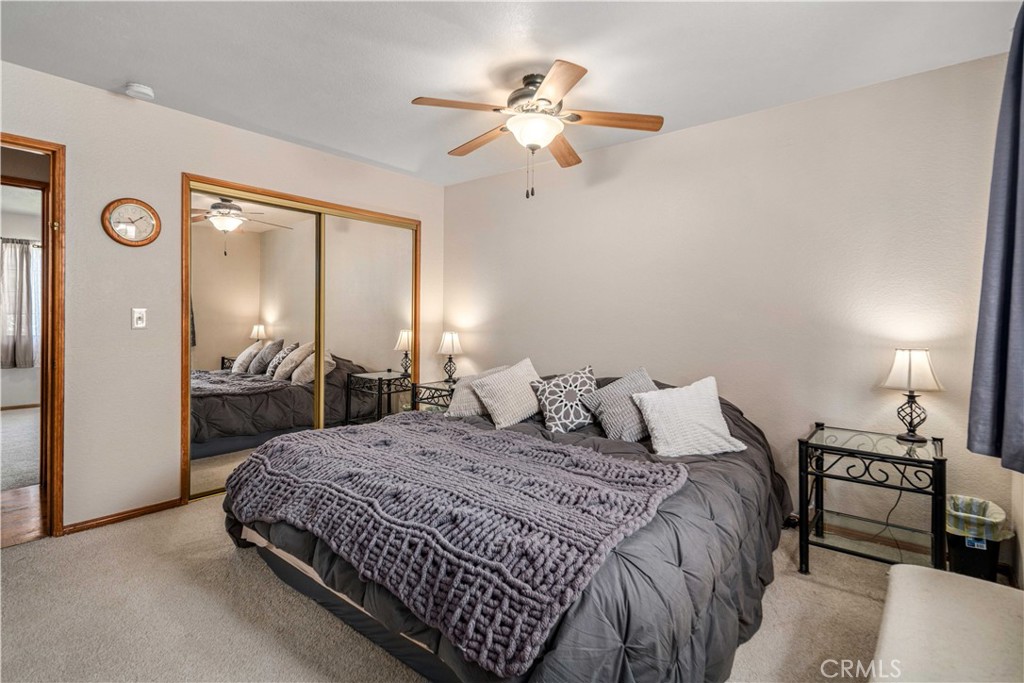 43230 Lookabout Road Lake Hughes, CA 93532 - Photo 17 of 40 a bedroom with a bed and a chandelier