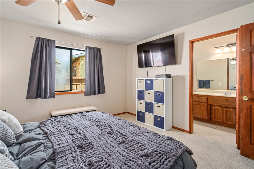43230 Lookabout Road Lake Hughes, CA 93532 - Photo 18 of 40 a bedroom with a bed and a flat screen tv
