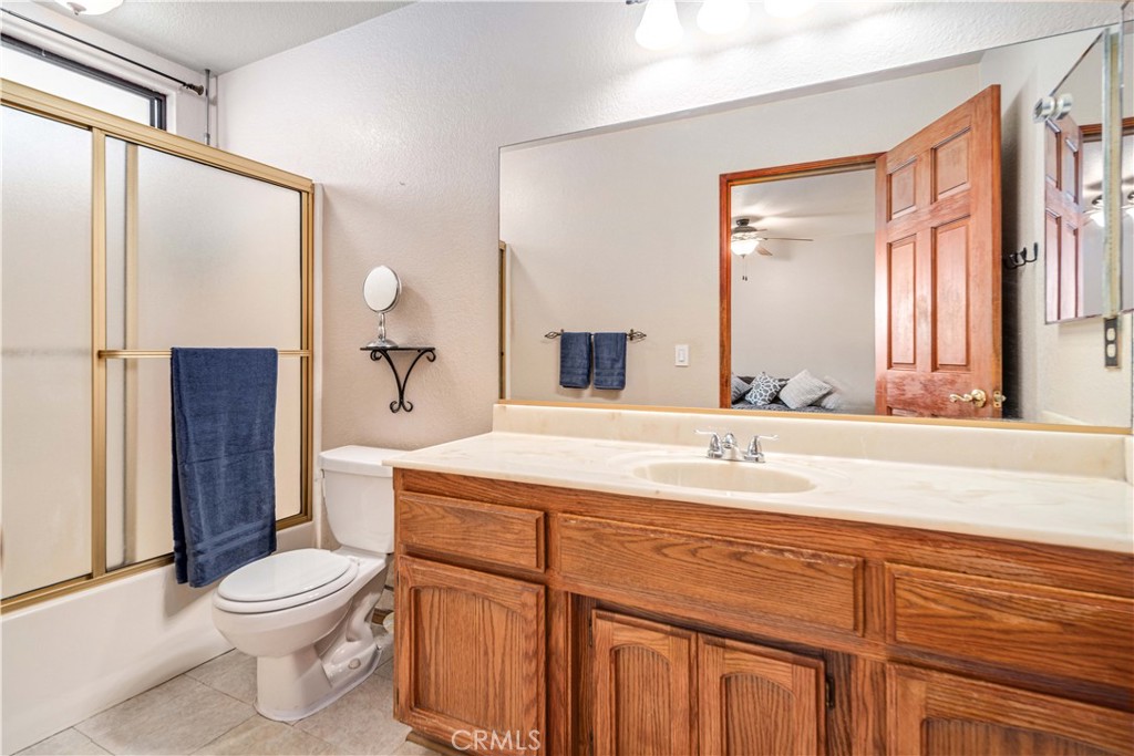 43230 Lookabout Road Lake Hughes, CA 93532 - Photo 19 of 40 a bathroom with a toilet a sink and a large mirror
