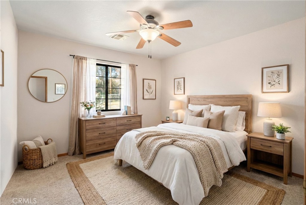 43230 Lookabout Road Lake Hughes, CA 93532 - Photo 20 of 40 a bedroom with a large bed and a chandelier