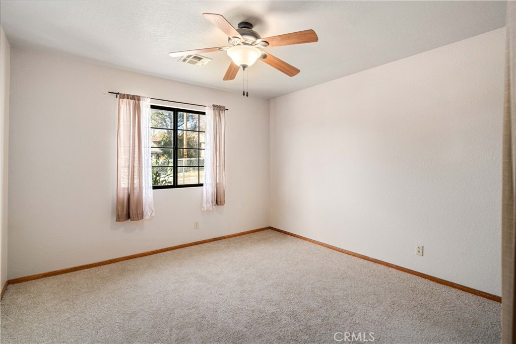 43230 Lookabout Road Lake Hughes, CA 93532 - Photo 21 of 40 an empty room with windows and fan