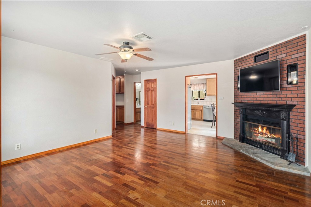 43230 Lookabout Road Lake Hughes, CA 93532 - Photo 6 of 40 a view of an empty room with a fireplace and a window