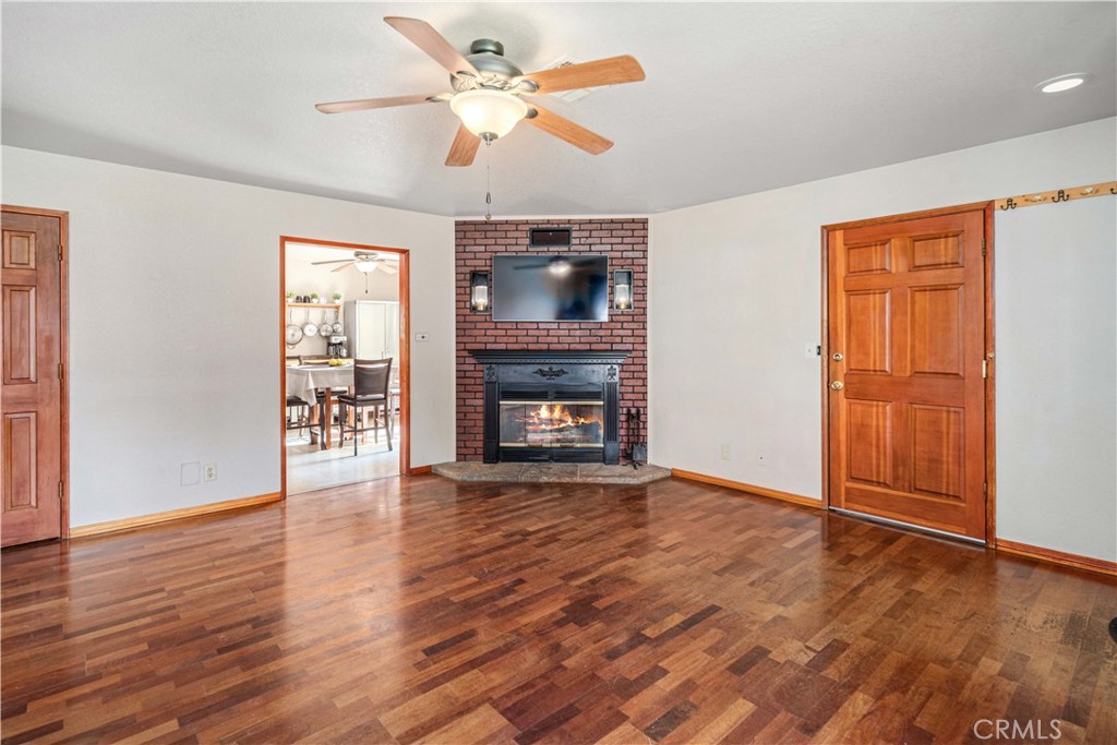 43230 Lookabout Road Lake Hughes, CA 93532 - Photo 7 of 40 a view of an empty room with wooden floor fireplace and a window
