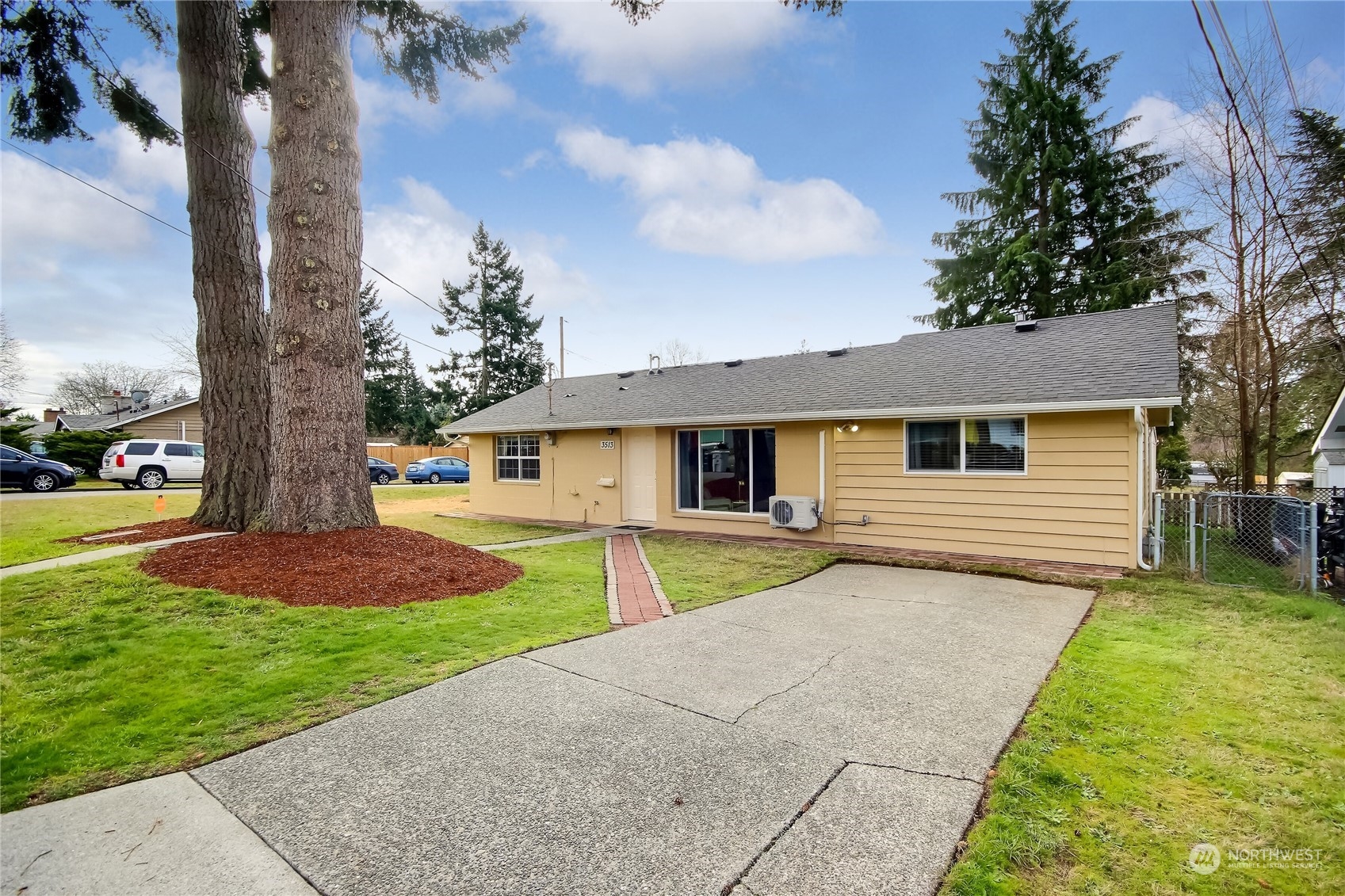 3513 Northeast 9th Street Renton, WA 98056 - Photo 1 of 40 a front view of a house with a yard and trees