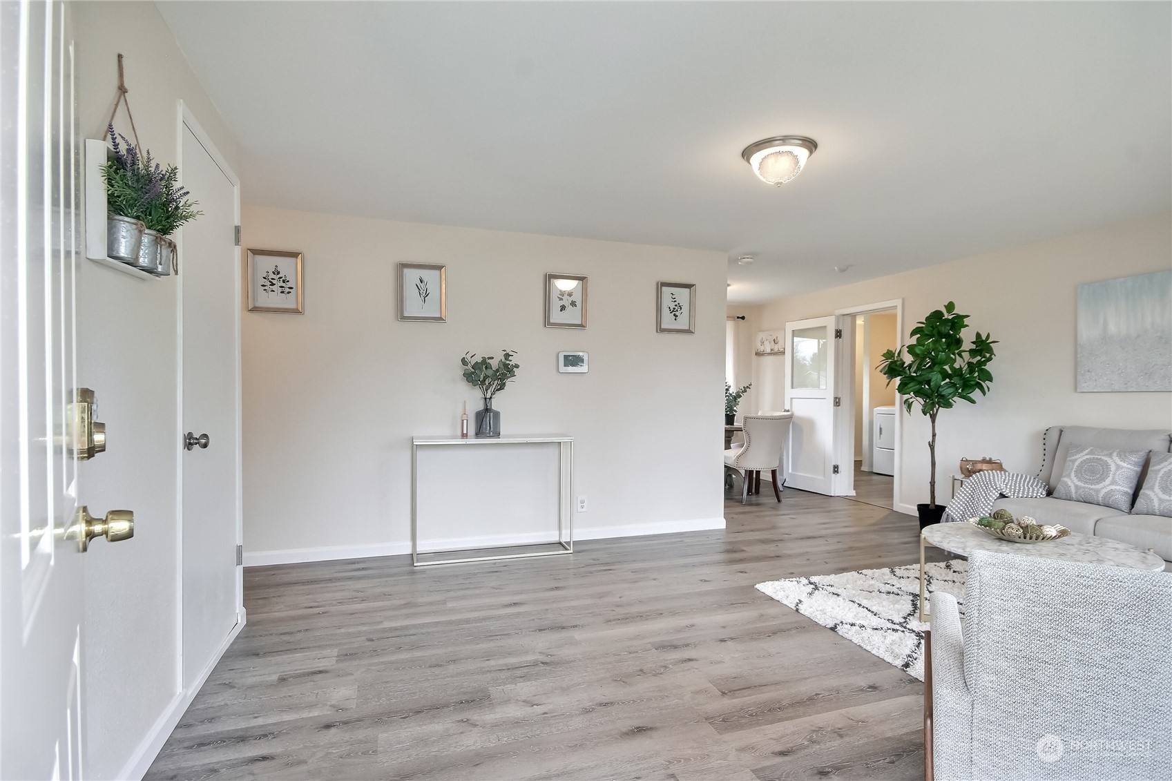 3513 Northeast 9th Street Renton, WA 98056 - Photo 8 of 40 a view of a livingroom with wooden floor and a hallway