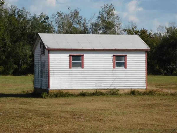 a side view of a house with a yard