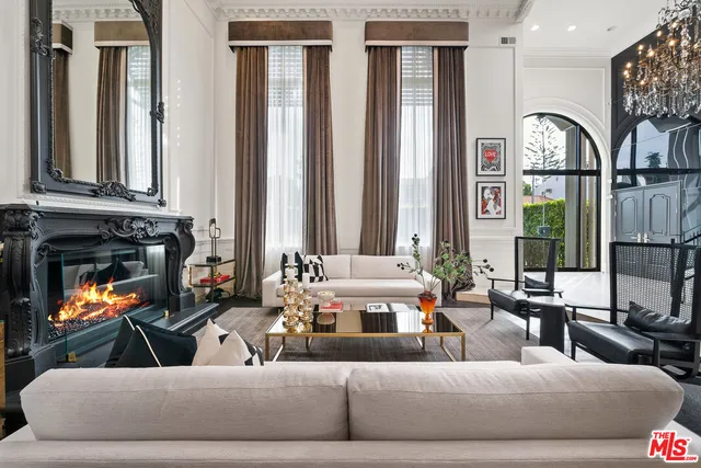 a living room with furniture and large windows