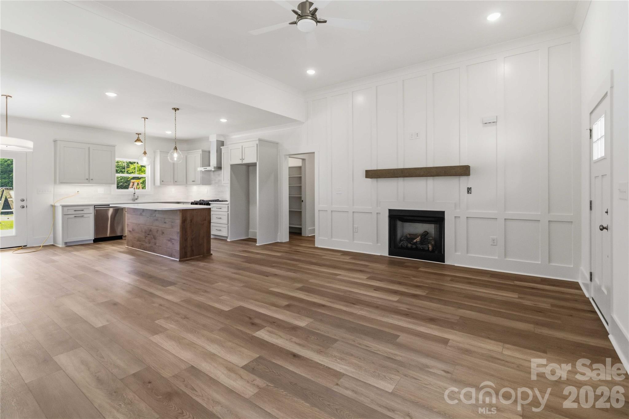 352 Adams Road Clover, SC 29710 - Photo 5 of 38 a view of kitchen and fireplace with wooden floor