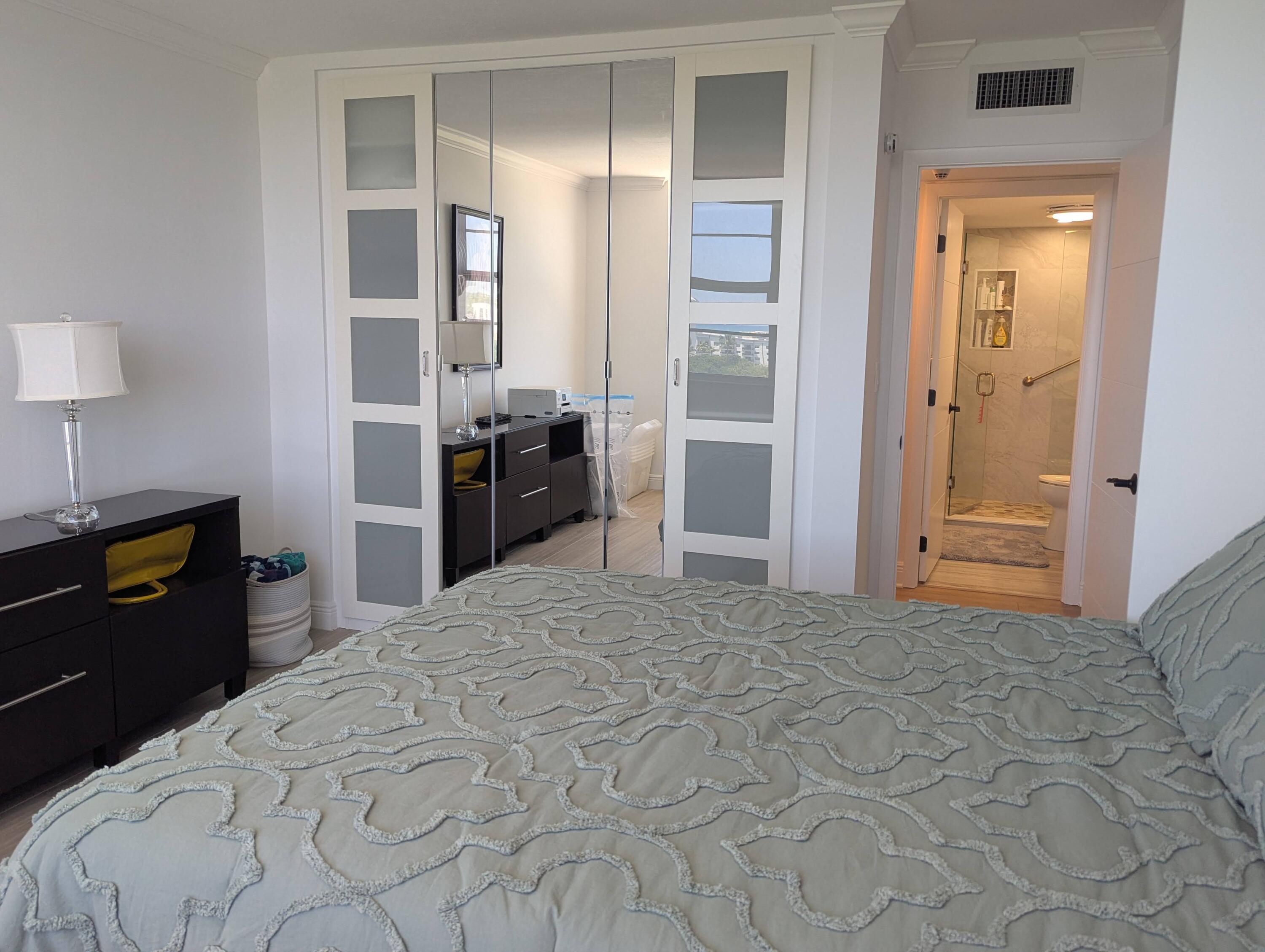 2121 North Ocean Boulevard, Unit 1006E Boca Raton, FL 33431 - Photo 19 of 64 a large bedroom with a bed and a dresser