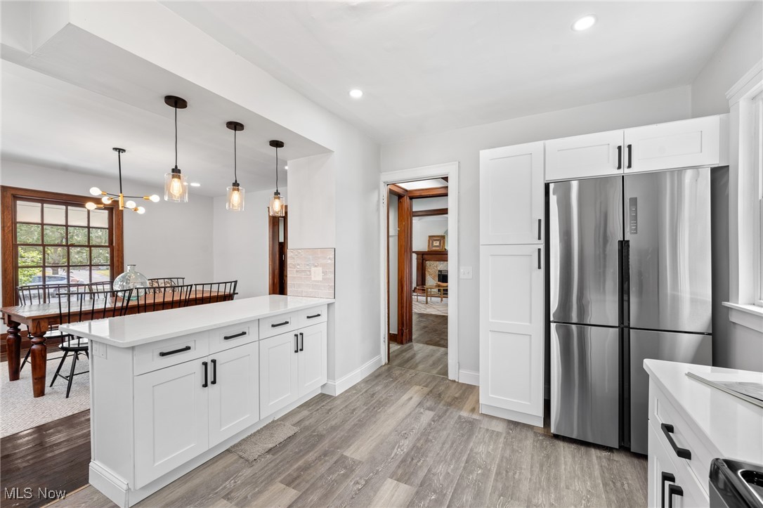 3139 Whitethorn Road Cleveland, OH 44118 - Photo 18 of 50 Kitchen featuring decorative backsplash, a chandelier, stainless steel refrigerator, and light wood-type flooring
