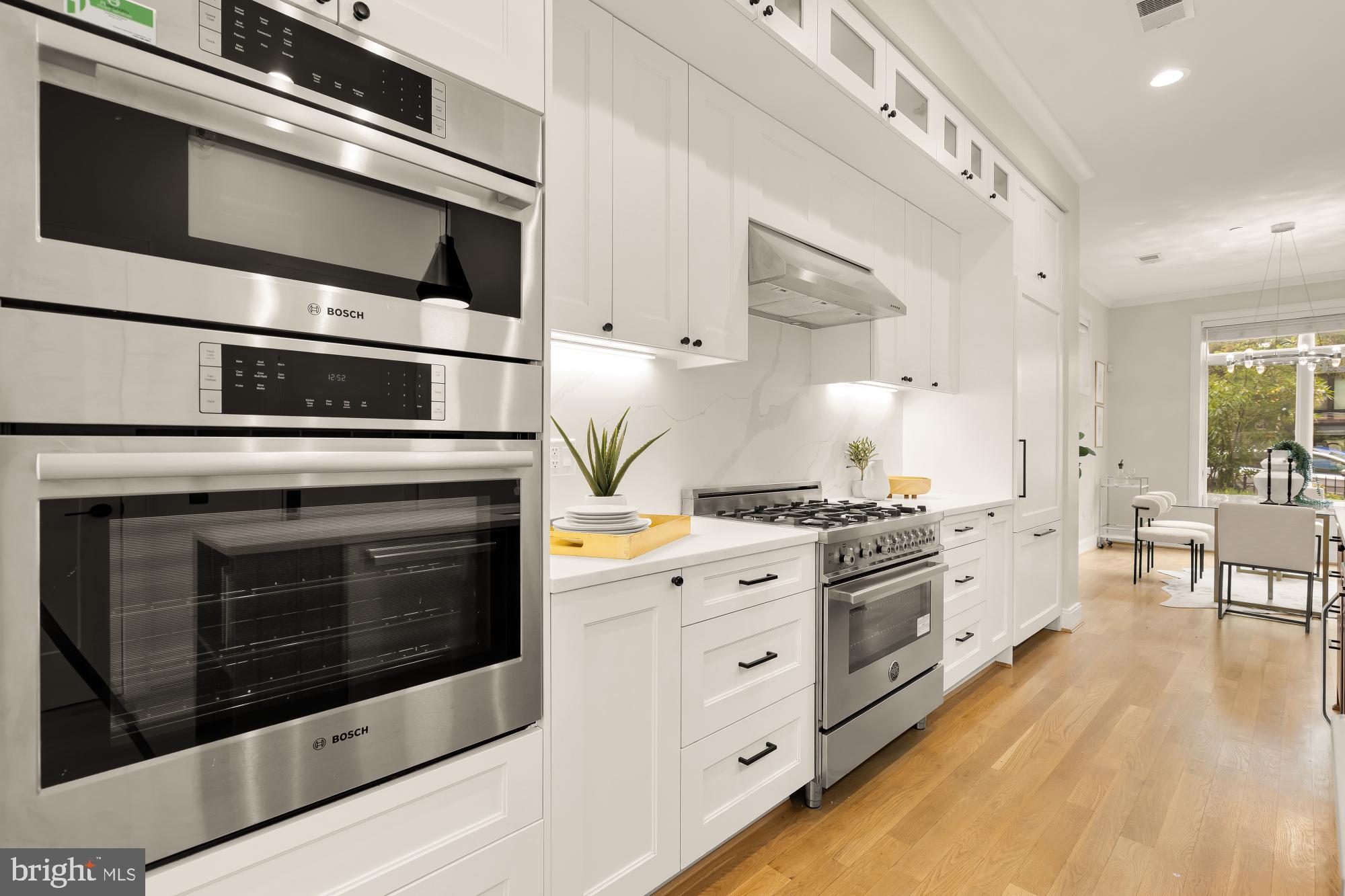 a kitchen with stainless steel appliances a stove microwave and cabinets