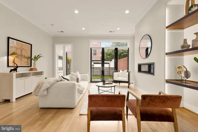 a living room with furniture a rug and a painting