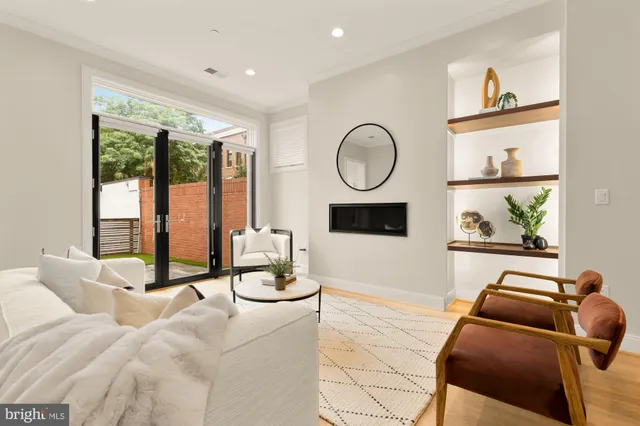 a living room with furniture a couch and kitchen view