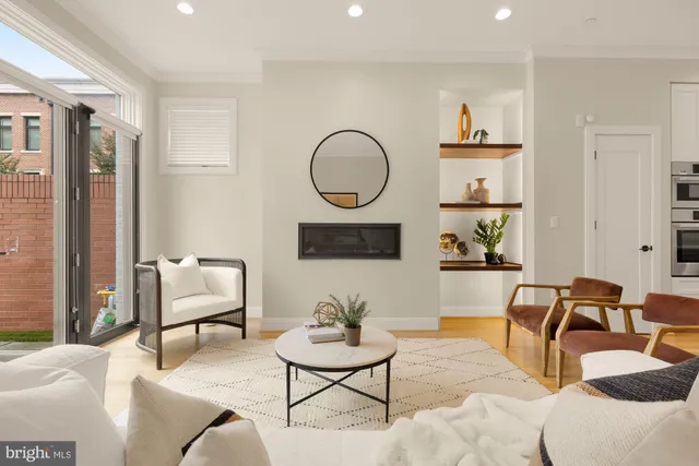 a living room with furniture and potted plant