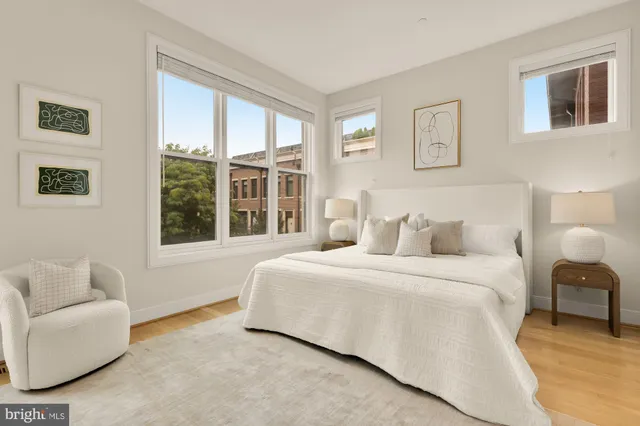 a bedroom with a bed and a large window