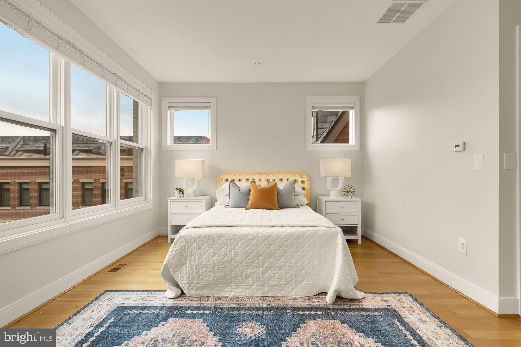 1311 D Street Southeast Washington, DC 20003 - Photo 36 of 57 a bedroom with a bed and wooden floor