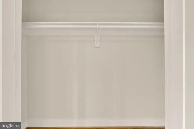 a bedroom with bed and a large window