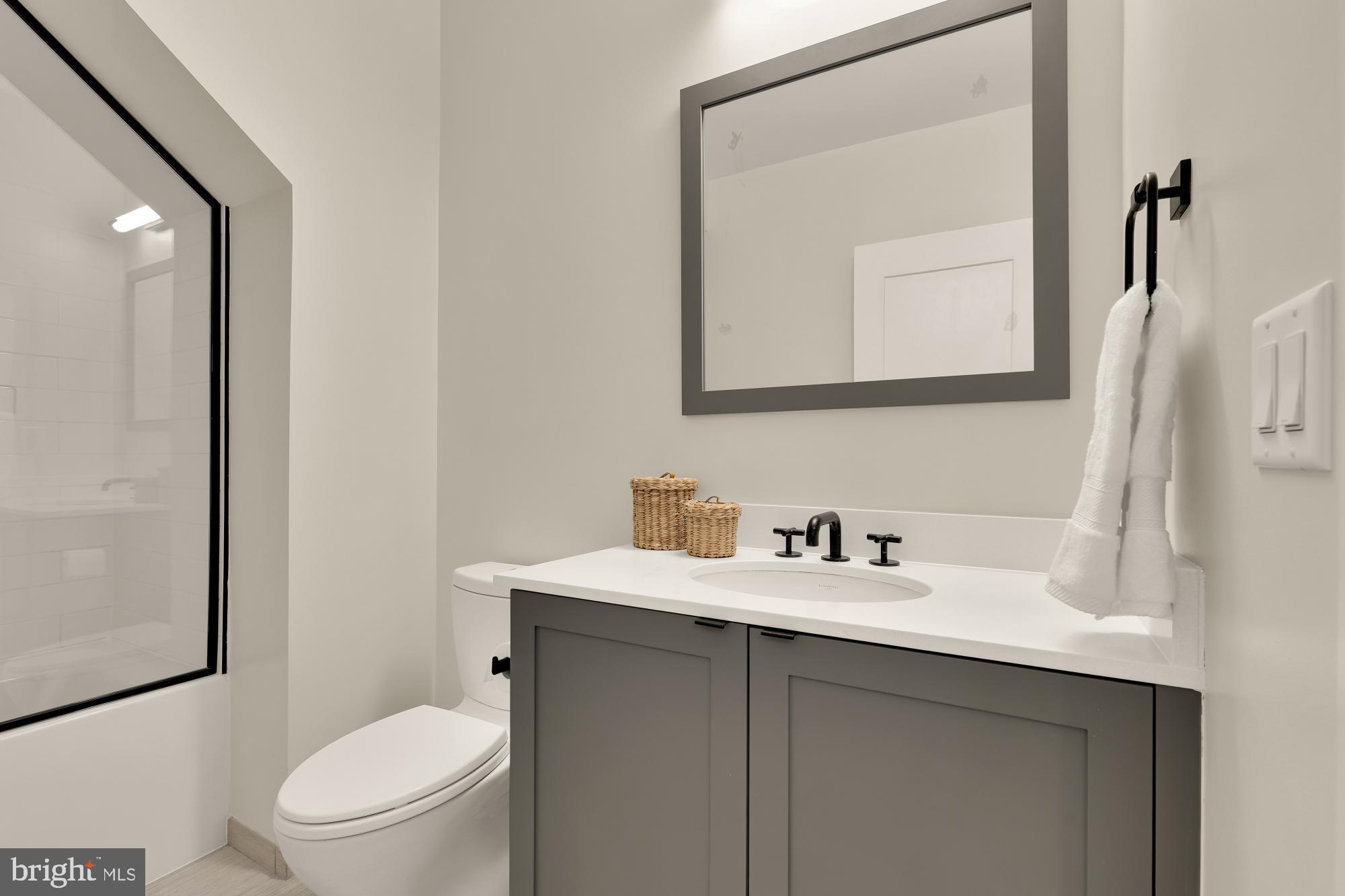 1311 D Street Southeast Washington, DC 20003 - Photo 45 of 57 a bathroom with a toilet sink vanity and mirror