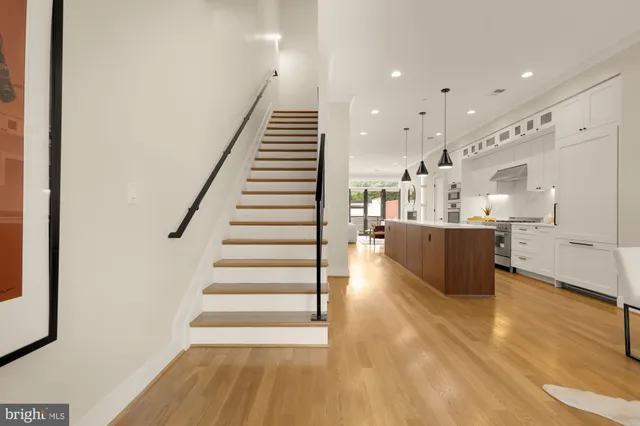 a view of an empty room with window and refrigerator