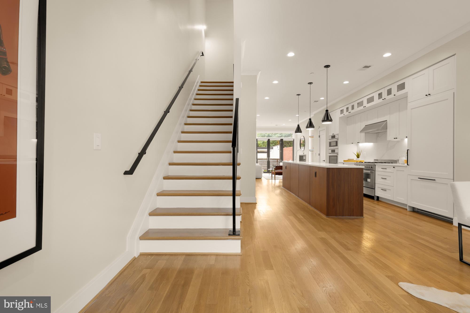 1311 D Street Southeast Washington, DC 20003 - Photo 6 of 57 a view of kitchen with wooden floor and electronic appliances