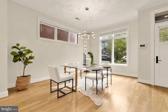 a view of a dining room with furniture window and wooden floor